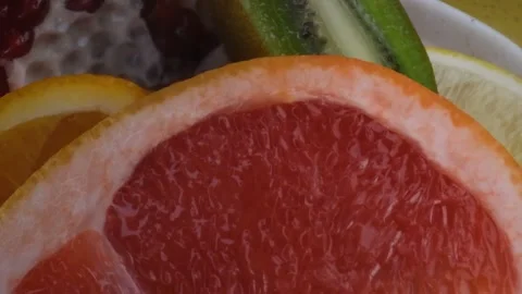 Assorted fresh fruit, grapefruit,splashes of water on fruit, fresh juice Stock Footage 131603970