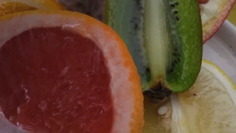 Assorted fresh fruit, grapefruit,splashes of water on fruit, fresh juice Stock Footage 131604278