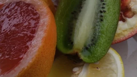Assorted fresh fruit, grapefruit,splashes of water on fruit, fresh juice Stock Footage 131604682
