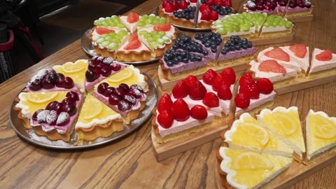 Assorted Fresh Fruit Tarts and Gourmet Cream Cheese Pastries Variety Pack Stock Footage 337751330