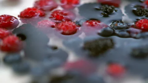Assorted fresh healthy berries falling into water Stock Footage 135382720