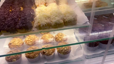 Assorted fresh pastries and bread displayed in a bakery showcase Stock-Footage 341897981