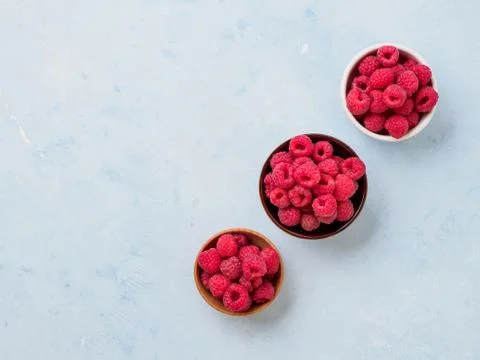 Assorted fresh raspberry in different plates. Stock Photos