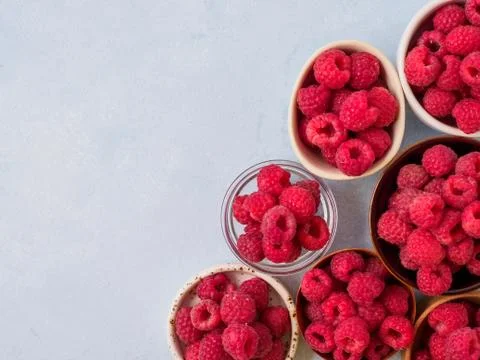 Assorted fresh raspberry in different plates. Stock Photos