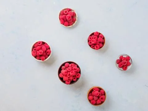 Assorted fresh raspberry in different plates. Stock Photos