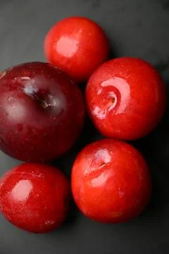 Assorted Fresh Red Plums With Water Droplets On Dark Background 写真素材