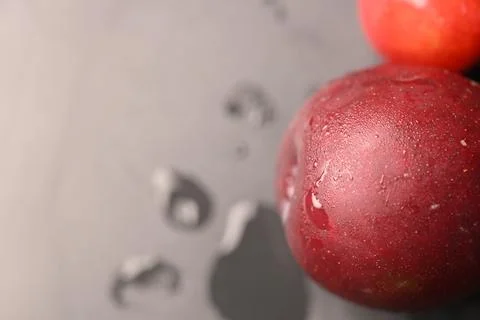 Assorted Fresh Red Plums With Water Droplets On Dark Background Stock Photos
