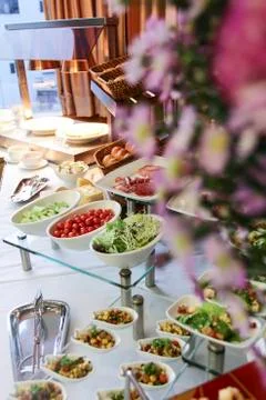 Assorted fresh salads displayed on a buffet, individual containers at catered Stock Photos