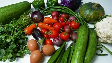 Assorted Fresh Vegetables and Eggs on White Surface, A colorful assortment .. Stock Footage 305033602