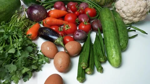 Assorted Fresh Vegetables and Eggs on White Surface, A colorful assortment .. 動画素材 305033694