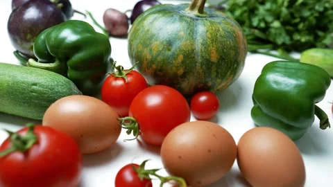 Assorted Fresh Vegetables and Eggs on White Background, A variety of fresh .. Stock Footage 305060232