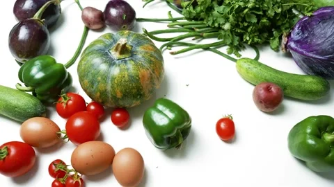 Assorted Fresh Vegetables and Eggs on White Surface, A variety of fresh veg.. Stock Footage 305060353