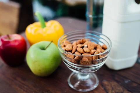 Assorted fresh vegetables, peppers, apples, water and milk on wooden table. yoga Stock Photos