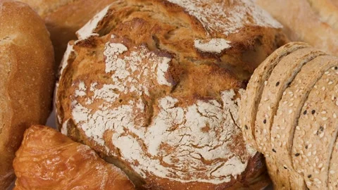 Assorted Freshly Baked Artisan Breads and Pastries on White Background Stock Footage 337997322