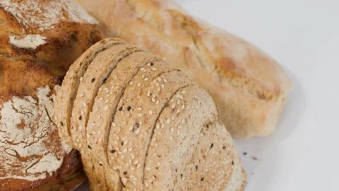 Assorted Freshly Baked Bread and Pastries on White Background Stock Footage 338319179