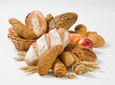 Assorted freshly baked breads with wheat ears Stock Photos