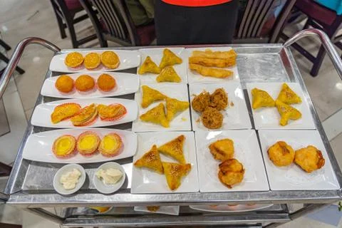 Assorted of fried dumplings and egg tarts on dimsum cart Foto stock