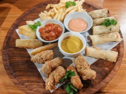 Assorted Fried Snack Platter with French Fries Spring Rolls Nuggets Stock Photos