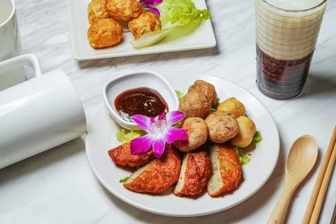 Assorted Fried Snacks with fish cake, Fried squid balls, Dipping Sauce, Tai.. Stock Photos