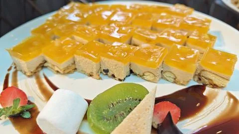 Assorted Fruit and Cream Layer Cake with Jelly Topping on Dessert Serving Plate 写真素材