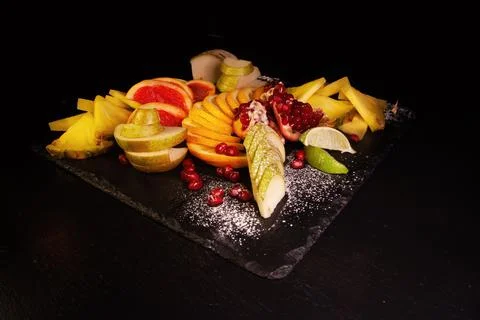 Assorted fruit on a black background Stock Photos