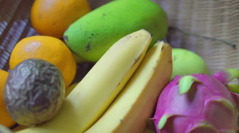 Assorted fruit: mango, dragon fruit, passionfruit, banana and oranges Stock Footage 67675364