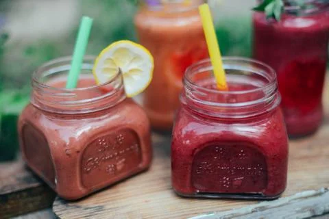 Assorted fruit shakes on white table. Smoothie concept. Selection of colorful Stock Photos