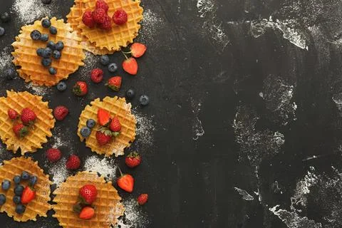 Assorted fruit tartlets with berries on dark background Stock Photos