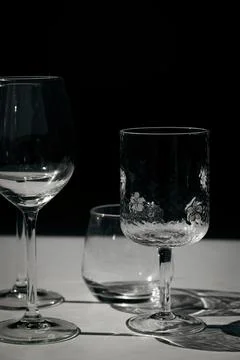 Assorted glassware for various drinks in sunlight Stock Photos