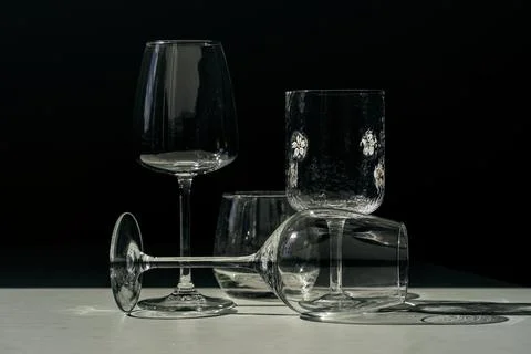 Assorted glassware for various drinks in sunlight Stock Photos