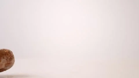 Assorted glazed and chocolate cake donuts bouncing on white slow motion macro Stock Footage 336707113