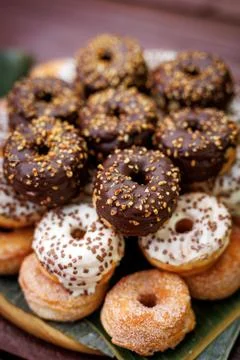 Assorted glazed donuts with sprinkles Stock Photos