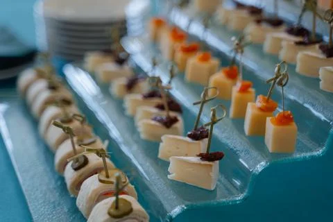 Assorted gourmet appetizers displayed elegantly on a glass platter Stock Photos