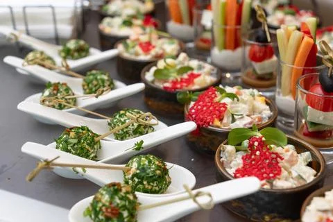 Assorted gourmet appetizers, vegetable sticks, and salads Stockfoto's