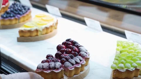 Assorted Gourmet Fruit Tarts on Display in Bakery Window Stock-Footage 343019127