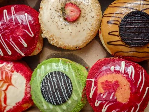 Assorted Gourmet Glazed Donuts in Box Top View 库存照片