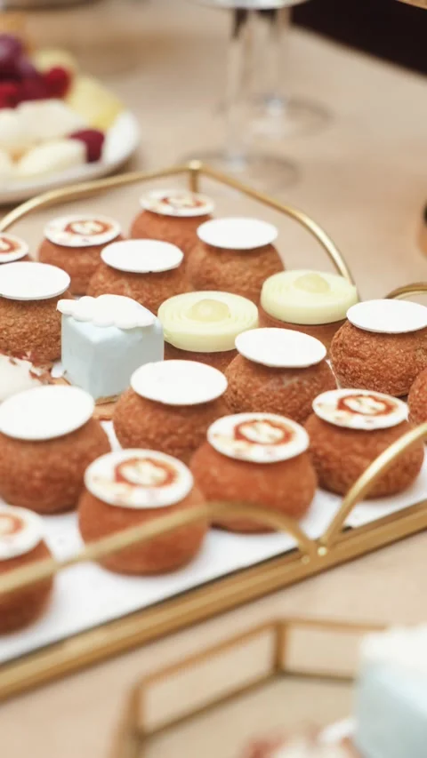 Assorted gourmet mini desserts and pastries elegantly arranged on serving trays Vidéo 341476732
