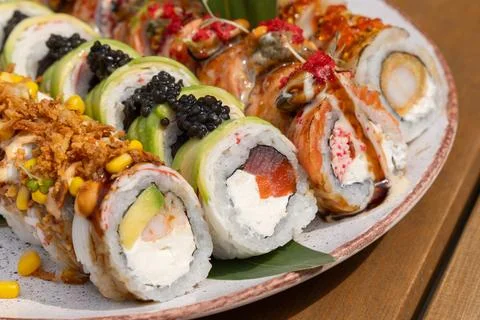 Assorted gourmet sushi roll set with salmon, tuna, shrimp, avocado, black and 写真素材