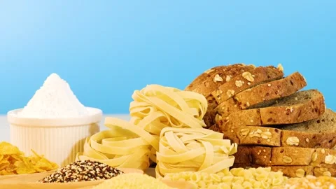 Assorted Grains and Breads on Blue Background Vídeo Stock 310153620