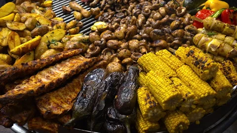 Assorted grilled meat and vegetables on barbecue grill Stock Footage 323802123