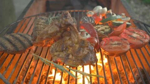 Assorted grilled meat with vegetables, in the foreground burger cutlet, steak Foto stock