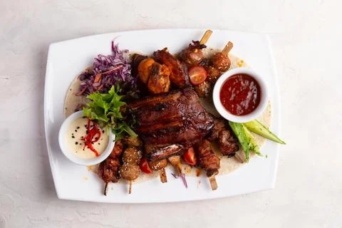 Assorted grilled meats. On a light background. Stock Photos