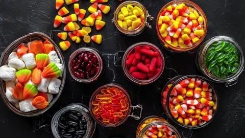 Assorted Halloween Candy Jars with Candy Corn and Gummies Stock Footage 282433873
