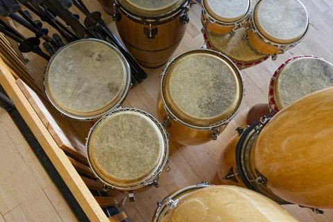 Assorted hand drums with worn skins and dark centers Stock Photos