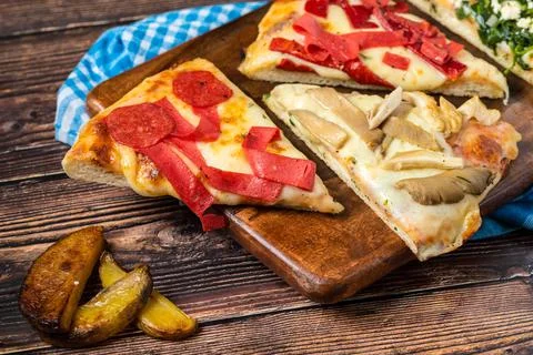 Assorted handmade Argentinian pizza on stone background. Stock Photos