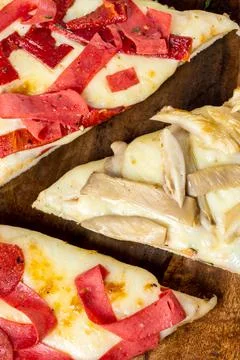 Assorted handmade Argentinian pizza on stone background. Stock Photos