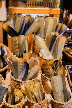 Assorted handmade combs displayed in woven baskets showcasing craftsmanship.. Stock Photos
