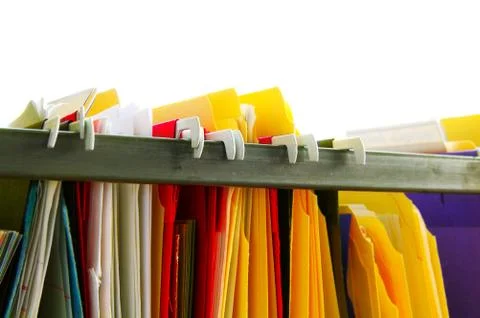 Assorted hanging file folders on white background Stock Photos