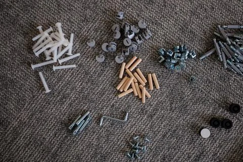 Assorted Hardware Components Organized on Textured Carpet Surface Stock Photos
