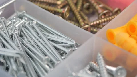 Assorted hardware like screws nails and wall plugs organized in plastic con.. Stock Footage 331725926